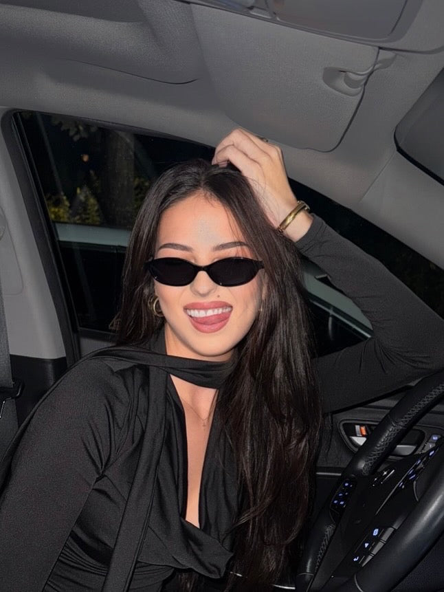 Woman wearing EYENEED eyewear in a car